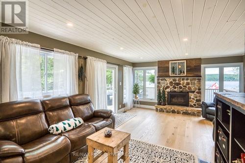 1039 West Cottage Drive W, North Frontenac, ON - Indoor Photo Showing Living Room With Fireplace