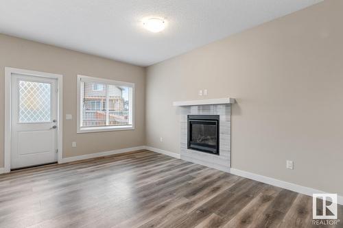 8538 Cushing Pl Sw, Edmonton, AB - Indoor Photo Showing Living Room With Fireplace