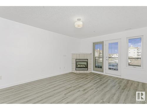 #216 261 Youville E Nw, Edmonton, AB - Indoor Photo Showing Living Room With Fireplace