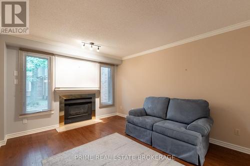 8 - 70 Sunnyside Drive, London, ON - Indoor Photo Showing Living Room With Fireplace