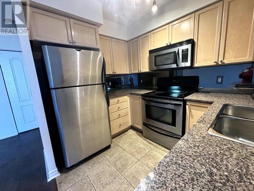 711 - 4080 Living Arts Drive, Mississauga, ON - Indoor Photo Showing Kitchen With Stainless Steel Kitchen With Double Sink