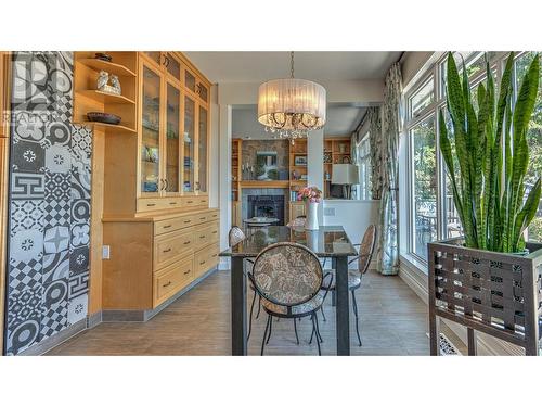 10220 Columbia Way, Vernon, BC - Indoor Photo Showing Dining Room With Fireplace