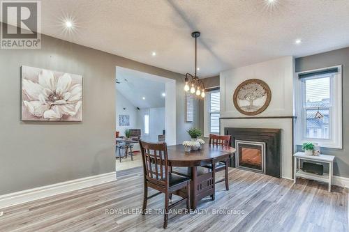 115 Loggers Grove, London, ON - Indoor Photo Showing Dining Room With Fireplace