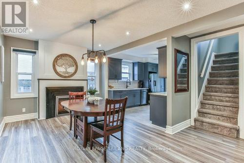 115 Loggers Grove, London, ON - Indoor Photo Showing Dining Room With Fireplace