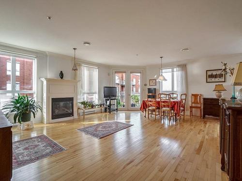 Overall view - 708-3050 Boul. Notre-Dame, Laval (Chomedey), QC - Indoor Photo Showing Living Room With Fireplace