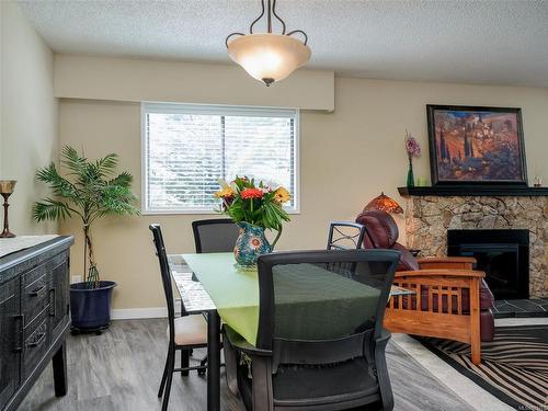 24-3958 Cedar Hill Rd, Saanich, BC - Indoor Photo Showing Dining Room With Fireplace