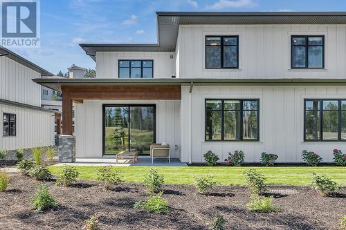 Rear patio - Photo of a similar home in the community. - 1979 Country Club Drive Unit# 7, Kelowna, BC - Outdoor