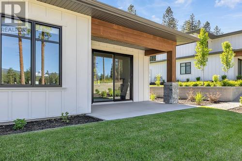 Rear patio and backyard - Photo of a similar home in the community. - 1979 Country Club Drive Unit# 7, Kelowna, BC - Outdoor