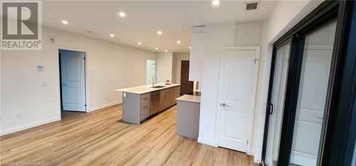 Kitchen featuring dishwasher, light hardwood / wood-style flooring, and sink - 525 New Dundee Road Unit# 602, Kitchener, ON - Indoor Photo Showing Other Room