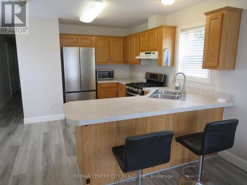 kitchen with light oak cabinets - 116 - 2189 Dundas Street E, London, ON - Indoor Photo Showing Kitchen With Double Sink