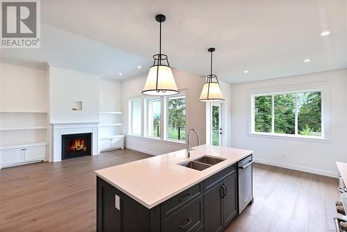 1824 Crown Isle Blvd, Courtenay, BC - Indoor Photo Showing Kitchen With Fireplace With Double Sink