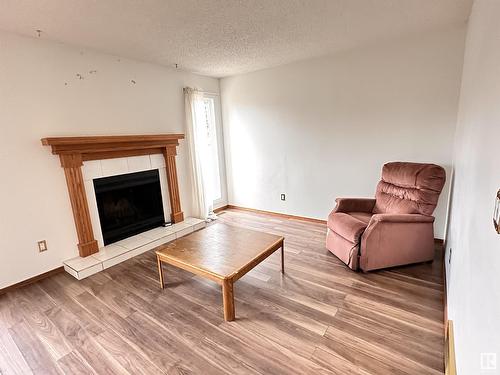 920 Lakewood N Nw, Edmonton, AB - Indoor Photo Showing Living Room With Fireplace