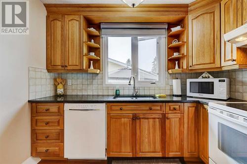 940 Rundlecairn Way Ne, Calgary, AB - Indoor Photo Showing Kitchen With Double Sink