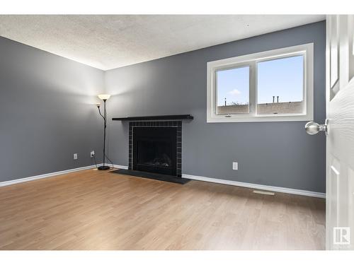 3191 139 Av Nw Nw, Edmonton, AB - Indoor Photo Showing Living Room With Fireplace