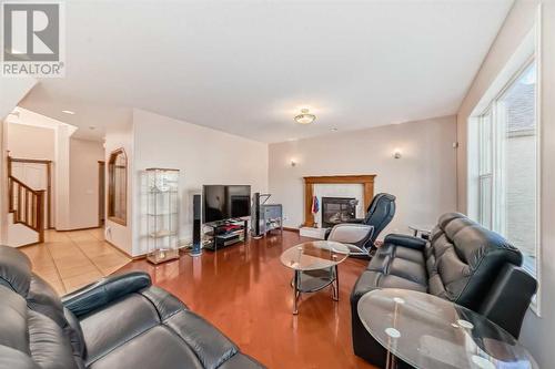 180 Panatella Close Nw, Calgary, AB - Indoor Photo Showing Living Room With Fireplace