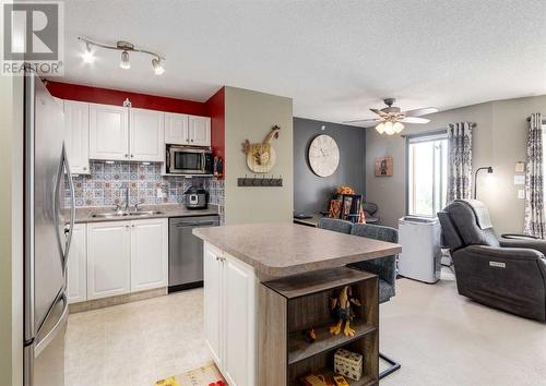 410, 6000 Somervale Court Sw, Calgary, AB - Indoor Photo Showing Kitchen With Double Sink