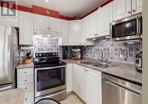 410, 6000 Somervale Court Sw, Calgary, AB - Indoor Photo Showing Kitchen With Double Sink