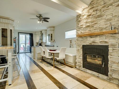 Dining room - 6 Rue Notre-Dame-De-Laval, Laval (Sainte-Rose), QC - Indoor With Fireplace