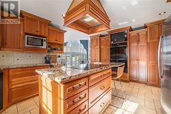 Double ovens and convenient Laundry space is tucked in cupboards in kitchen - 