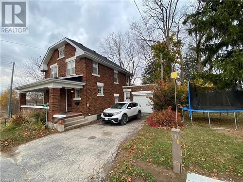 View of front of house featuring covered porch, a front yard, and a trampoline - 76 10Th Street, Hanover, ON - Outdoor