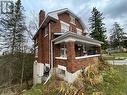 View of side of property featuring covered porch and ac unit - 76 10Th Street, Hanover, ON  - Outdoor 