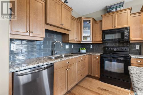 303 401 Cartwright Street, Saskatoon, SK - Indoor Photo Showing Kitchen With Double Sink