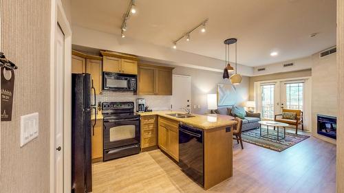 218C-1200 Rancher Creek Road, Osoyoos, BC - Indoor Photo Showing Kitchen With Fireplace With Double Sink