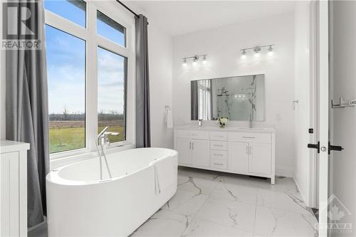 luxury ensuite with soaker tub and window - 13708 County Rd 15 Road, Merrickville, ON - Indoor Photo Showing Bathroom