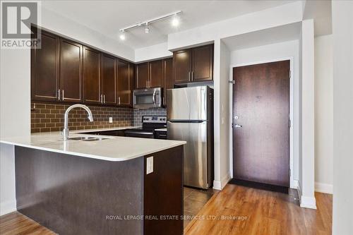 523 - 2480 Prince Michael Drive, Oakville, ON - Indoor Photo Showing Kitchen With Stainless Steel Kitchen With Double Sink