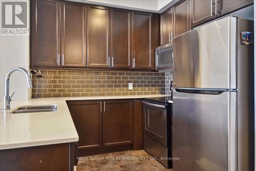 523 - 2480 Prince Michael Drive, Oakville, ON - Indoor Photo Showing Kitchen With Stainless Steel Kitchen With Double Sink