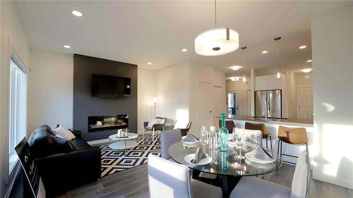 80 Cornerstone Heights, Winnipeg, MB - Indoor Photo Showing Dining Room With Fireplace