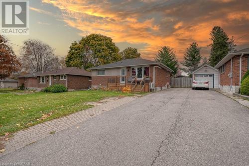 Ranch-style home featuring an outbuilding, a yard, and a garage - 824 Devonshire Avenue, Woodstock, ON - Outdoor