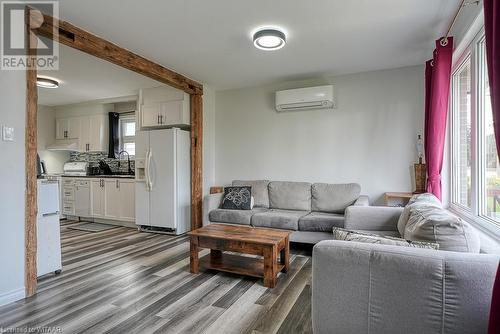 Living room with sink, hardwood / wood-style floors, and a wall mounted air conditioner - 824 Devonshire Avenue, Woodstock, ON - Indoor Photo Showing Living Room