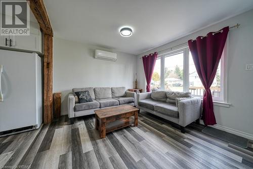 Living room with an AC wall unit and wood-type flooring - 824 Devonshire Avenue, Woodstock, ON - Indoor Photo Showing Living Room