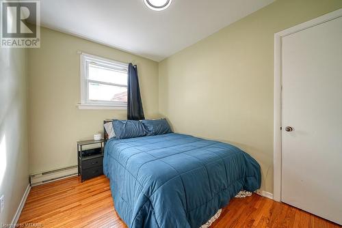 Bedroom with light hardwood / wood-style flooring and baseboard heating - 824 Devonshire Avenue, Woodstock, ON - Indoor Photo Showing Bedroom