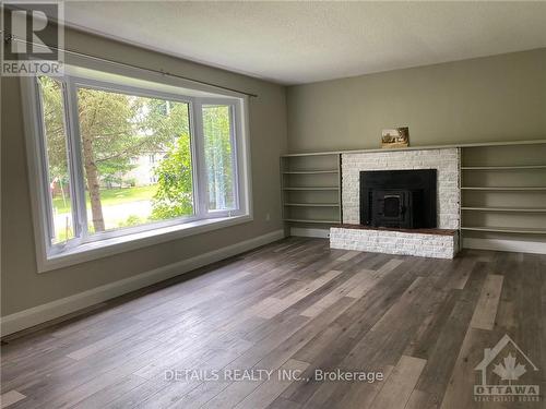 10617 Maple Street, North Dundas, ON - Indoor Photo Showing Living Room With Fireplace