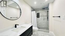 Bathroom with vanity, toilet, and a shower with curtain - 