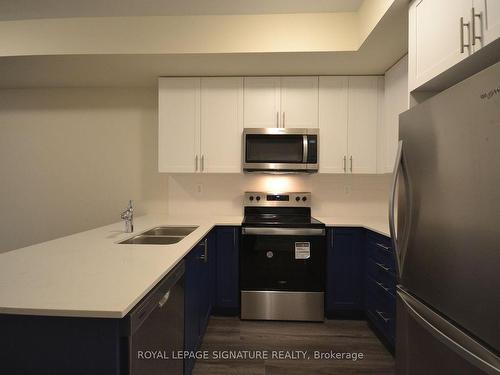 107-1573 Rose Way, Milton, ON - Indoor Photo Showing Kitchen With Stainless Steel Kitchen With Double Sink