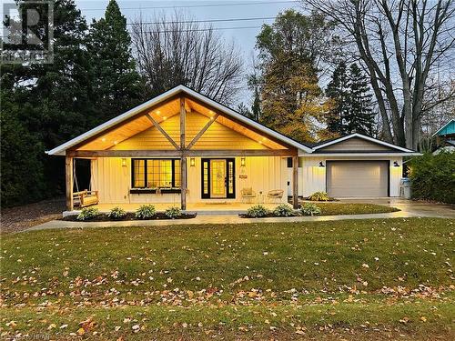 View of front facade with a front yard, a porch, and a garage - 31 Glass Street, Bayfield, ON - Outdoor