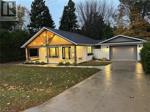 Ranch-style house with a front lawn, covered porch, and a garage - 31 Glass Street, Bayfield, ON - Outdoor