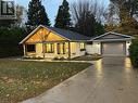 Ranch-style house with a front lawn, covered porch, and a garage - 31 Glass Street, Bayfield, ON  - Outdoor 