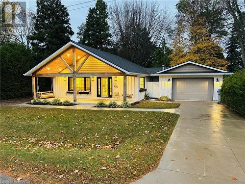 View of front of home with a garage, a front lawn, and a porch - 31 Glass Street, Bayfield, ON - Outdoor