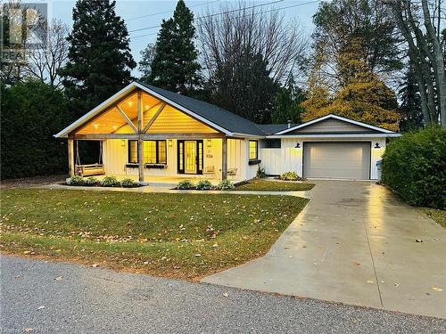 View of front of property with covered porch, a front lawn, and a garage - 31 Glass Street, Bayfield, ON - Outdoor