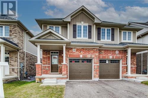 View of front of property featuring a garage and a porch - 26 Elsegood Drive, Guelph, ON - Outdoor With Facade