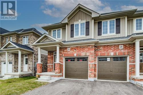 View of front of home with a garage and covered porch - 26 Elsegood Drive, Guelph, ON - Outdoor With Facade