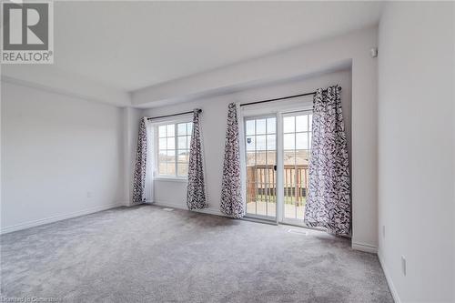 Empty room with carpet and a wealth of natural light - 26 Elsegood Drive, Guelph, ON - Indoor Photo Showing Other Room