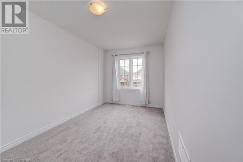 Empty room featuring light colored carpet - 26 Elsegood Drive, Guelph, ON - Indoor Photo Showing Other Room