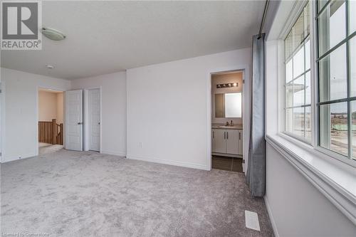 Unfurnished bedroom featuring light carpet, sink, and connected bathroom - 26 Elsegood Drive, Guelph, ON - Indoor Photo Showing Other Room