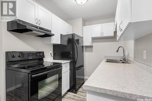 306 307 Tait Crescent, Saskatoon, SK - Indoor Photo Showing Kitchen With Double Sink