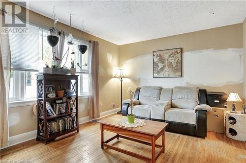 Living room with a textured ceiling and light hardwood / wood-style flooring - 55 Berkley Road, Cambridge, ON - Indoor Photo Showing Living Room